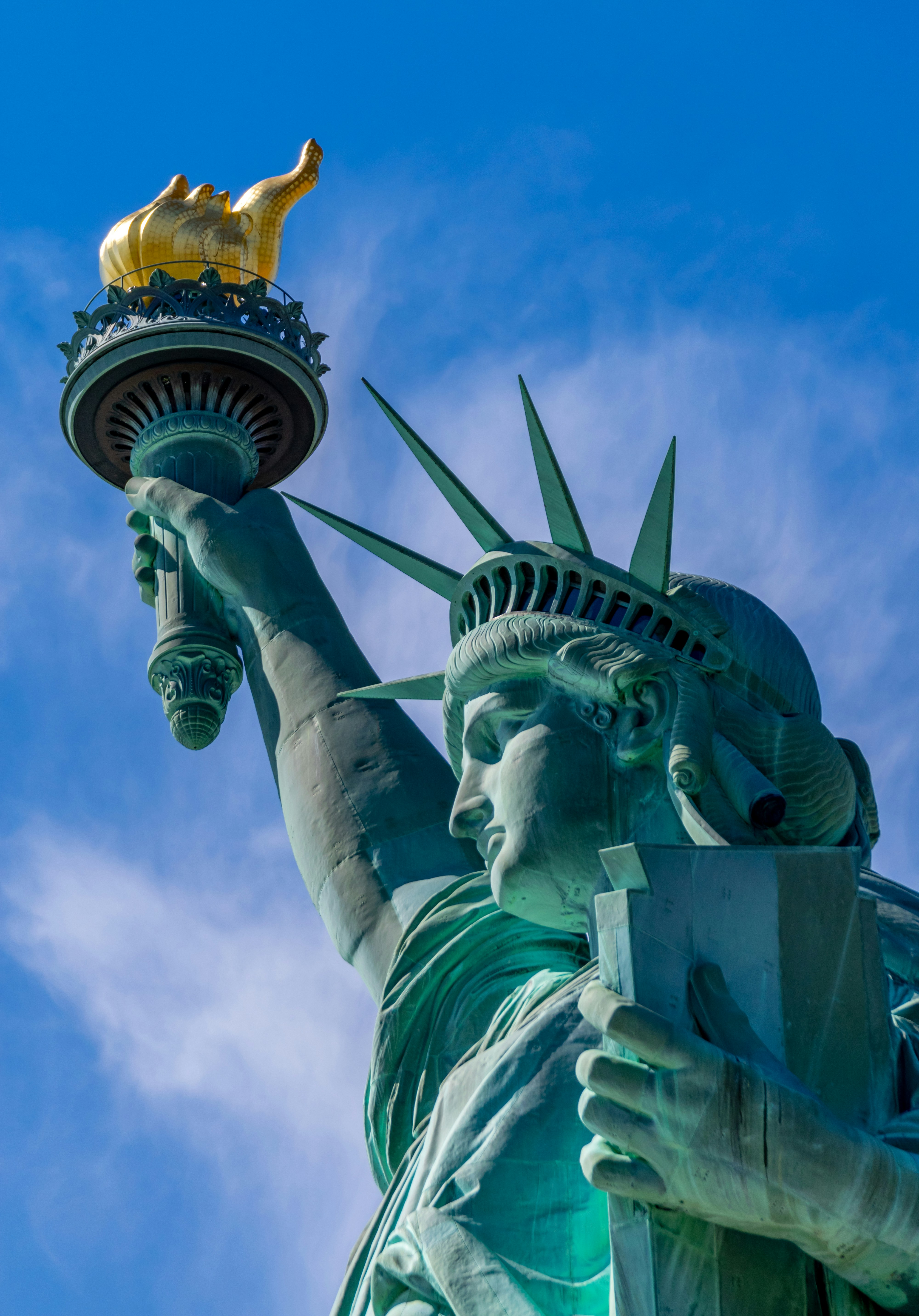 Close view of the Statue of Liberty against a blue sky