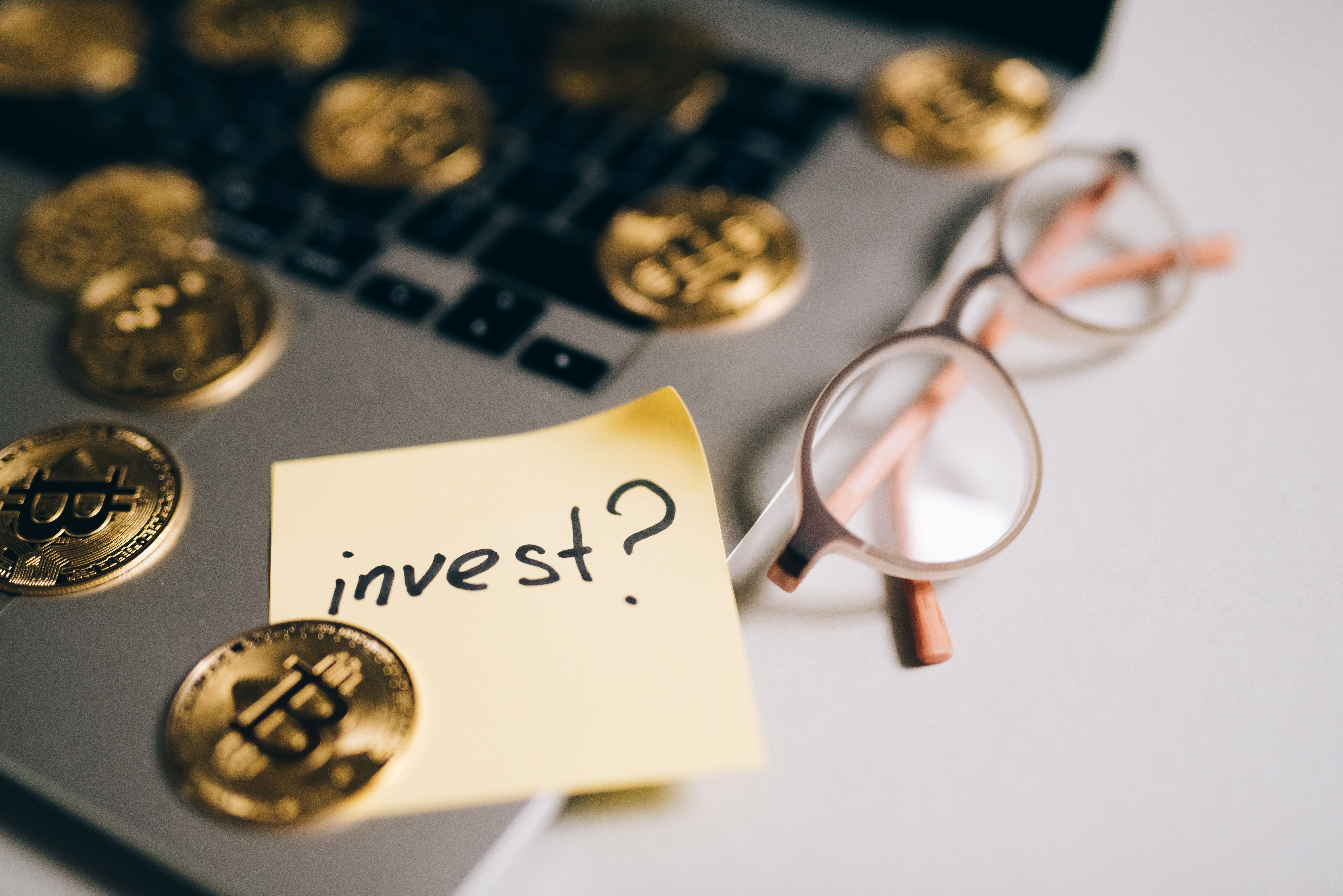 Investment planning notes beside a laptop